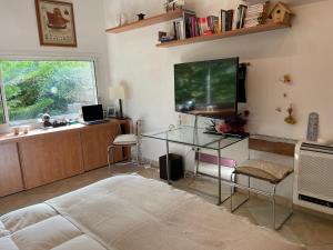 a living room with a television and a glass table at L'atelier du bonheur in Cassis