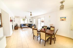 a dining room and living room with a table and chairs at Pedalion Villa in Protaras