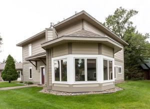 a house with a large window in the yard at Bay Colony Unit 771 - Upper Level in Nisswa