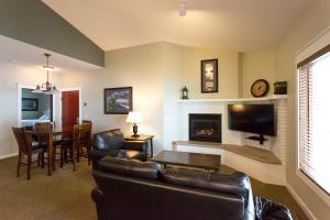 a living room with a couch and a fireplace at Bay Colony Unit 771 - Upper Level in Nisswa