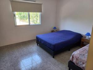 Ένα ή περισσότερα κρεβάτια σε δωμάτιο στο Casa quinta duplex Tortuguitas