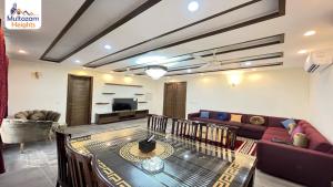 a living room with a couch and a table at Multazam Heights, DHA Phase 8 - 3 Bedrooms Luxury Apartments in Lahore