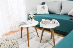 a living room with two tables and a couch at Apartment Atria in Vrnjačka Banja