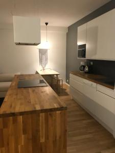 a kitchen with a wooden counter top in a room at City center apartment with sauna, Rovakatu 13 in Rovaniemi