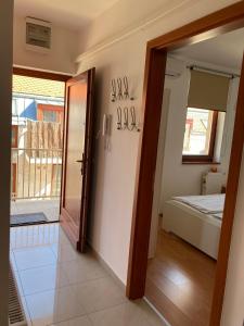 a hallway with a door leading to a bedroom at Germar Apartman in Pécs