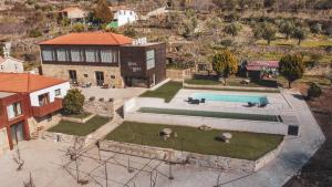 an aerial view of a house with a swimming pool at Quinta da Moita Agroturismo in Tabuaço
