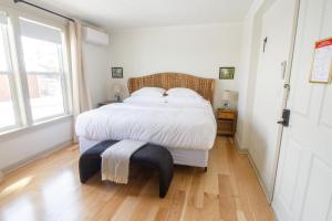 a bedroom with a large bed with a wooden floor at Pert House in Potsdam