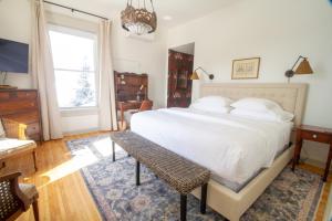 a bedroom with a large white bed and a window at Pert House in Potsdam