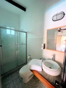 a bathroom with a toilet and a sink and a shower at HOTEL CAREY in Pedasí Town