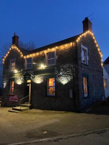 a building with lights on the side of it at Prestleigh inn in Shepton Mallet