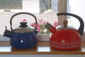 two teapots sitting on a counter next to a window at Vivienda Rural Cortijo de Liche in Arcos de la Frontera
