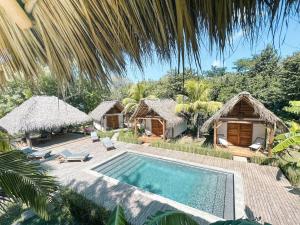 an image of a resort with a swimming pool at Monoloko Lodge Popoyo in Popoyo