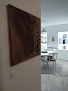 a dining room with a table and a painting on the wall at Kalymnos Gallery in Kalymnos