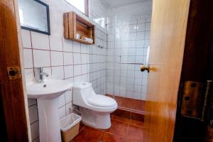 Un baño pequeño con inodoro y lavabo. en Hotel Fonda del Sol, en Panajachel