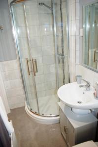 a bathroom with a shower and a sink at Gracehill Lodge - Guest Accommodation in Stranocum