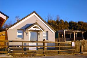 a house with a fence in front of it at Gracehill Lodge - Guest Accommodation in Stranocum