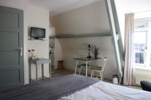 Postel nebo postele na pokoji v ubytování B&B - Pension Het Oude Dorp