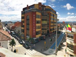 a large building in a city with a street at HOTEL ZUHE in Paipa