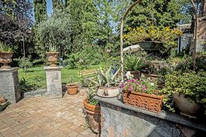 un jardín con un montón de macetas en Relais de Charme - B&B Short Lets La Casa di Francesca, en Sant’Agata Li Battiati 