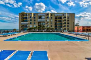 an empty swimming pool with a building in the background at Steps to Beach Scenic Condo in Ocean City! in Ocean City