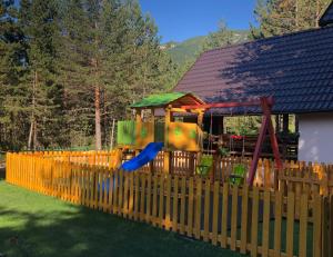 a playground with a slide in a yard at Vikendica Rita in Risovac