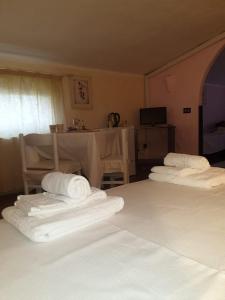 a hotel room with two beds with towels on them at Angelo e Arcangela in Telti