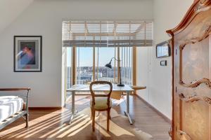 a bedroom with a desk and a bed and a window at Penthouse Aura by Q4Apartments in Gdańsk