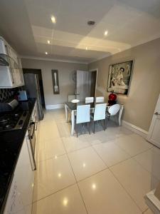 a kitchen and dining room with a table and chairs at WEST END -Stunning, 2 bedroom, main door flat with private parking in Glasgow