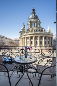 a table and chairs with a building in the background at Panorama Basilika suites with balcony NEED RESERVATION FOR FREE PARKING in Budapest