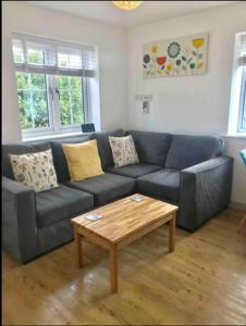 a living room with a blue couch and a coffee table at Miltons Holiday Let in Grimston