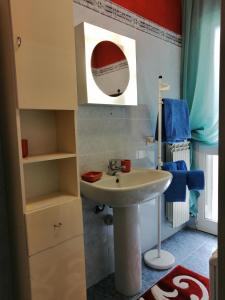 a bathroom with a sink and a mirror at Casa Dana Andora in Marina dʼAndora