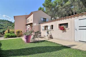 a house with a white fence and a yard at Les girardines in Manosque