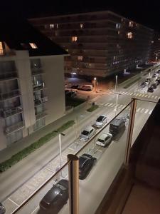 a view of a parking lot at night with cars parked at Marie-Alice IV in Nieuwpoort