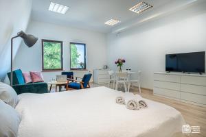 a bedroom with a bed and a flat screen tv at Park in Sopot