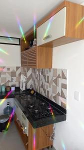 a kitchen with a stove with lights on it at Lindo Flat no Residencial Maraca Beach in Porto De Galinhas