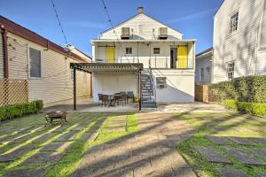 a patio with a table and a grill in front of a house at Uptown NOLA Apt on Magazine Street with Backyard! in New Orleans