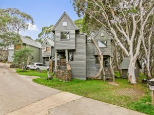 a gray house with a gambrel roof at Bogong Jacks in Dinner Plain