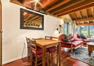 a dining room with a table and a couch at Bogong Jacks in Dinner Plain