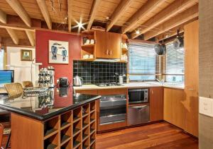 a kitchen with wooden cabinets and a black counter top at Bogong Jacks in Dinner Plain +1 photo