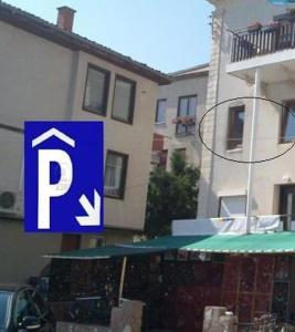 a blue and white parking sign in front of a building at Bilyana Apartments in Ohrid