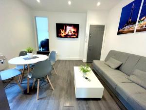 a living room with a couch and a table at Albert Luxury Hottub & Jacuzzi Apartments in Blackpool