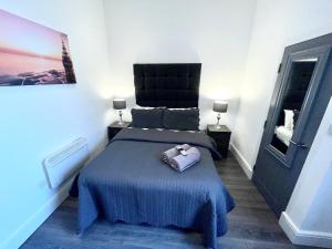 a bedroom with a bed with a purse on it at Albert Luxury Hottub & Jacuzzi Apartments in Blackpool
