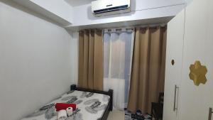 a bedroom with a bed with a tv on the ceiling at Sea Residences EZBedz in Manila