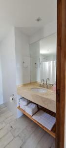 a bathroom with a sink and a mirror at DEPARTAMENTO AZ SUITE in Salta