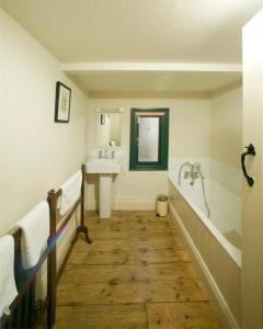 a bathroom with a bath tub and a sink at Castletown Round House in Celbridge