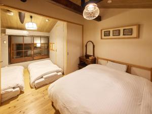 En eller flere senge i et værelse på Kyomachiya Higashiyama Sanjo Kanau