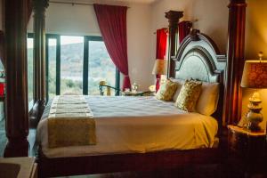 a bedroom with a large bed and a large window at Quiet Mind Mountain Lodge, Retreat & Spa in Julian