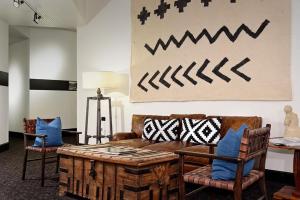 a living room with a couch and some chairs at Independence Square 206, Hotel Room with Central Location, Town Views, & Rooftop Hot Tub in Aspen
