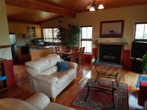 a living room with a couch and a fireplace at River Rock Estate in Cromwell