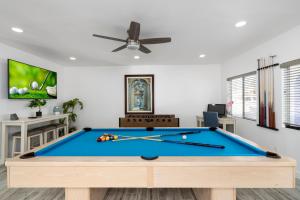 a pool table in a living room with a ceiling fan at Premier Host Villa-Heated Pool, Golf, Mayo Clinic in Phoenix